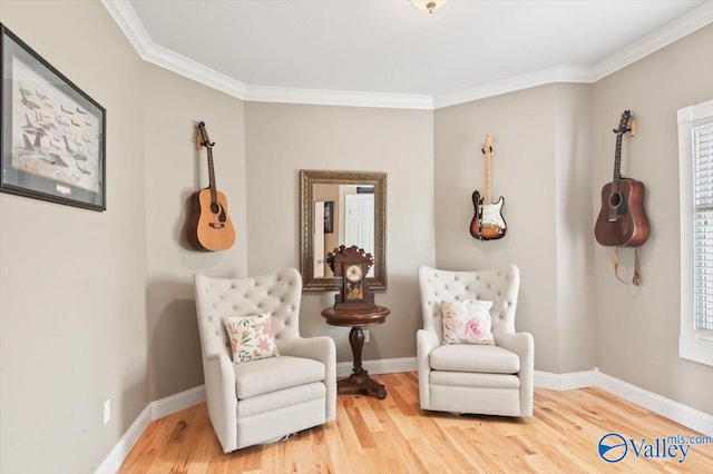 sitting room featuring hardwood / wood-style flooring, a healthy amount of sunlight, and crown molding