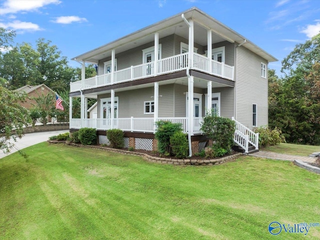 view of front facade with a front yard, a balcony, and a porch