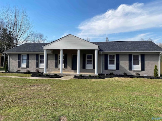 view of front of house with brick siding, a front yard, a porch, and a shingled roof
