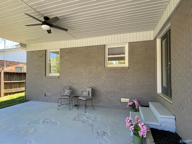 view of patio with ceiling fan and fence