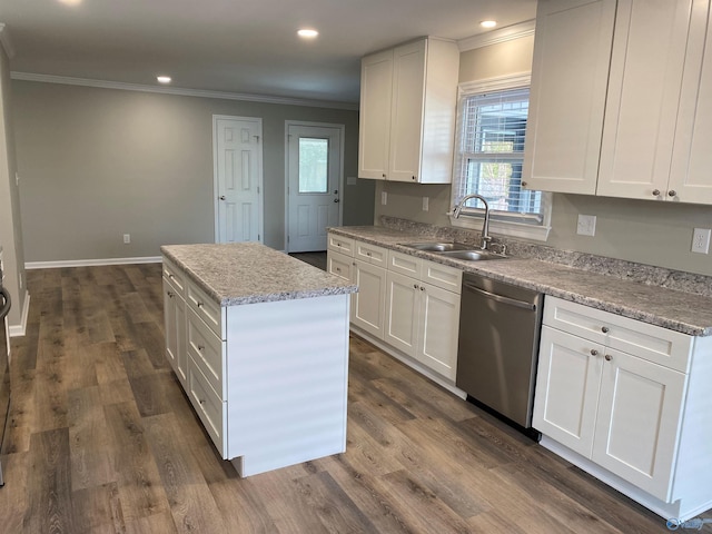 kitchen with crown molding, a wealth of natural light, a kitchen island, dishwasher, and a sink