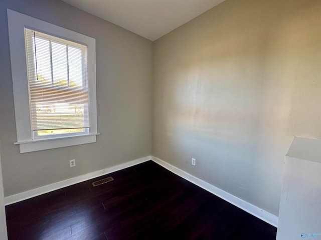 empty room with dark wood-type flooring