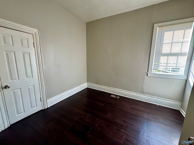 empty room with dark hardwood / wood-style floors