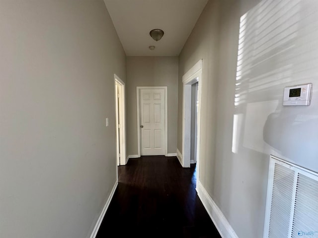 hallway with dark hardwood / wood-style floors