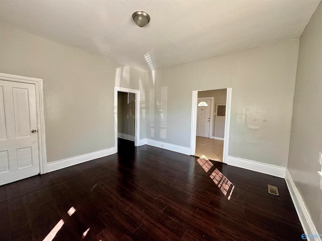 spare room with dark hardwood / wood-style flooring