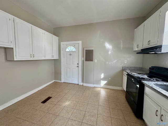 kitchen with white cabinets, light tile patterned floors, and electric range