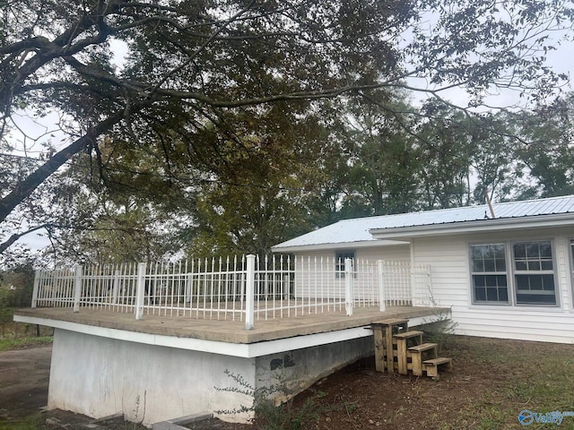 rear view of property with a wooden deck