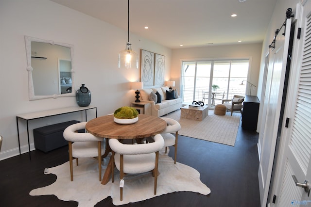 dining space featuring a barn door