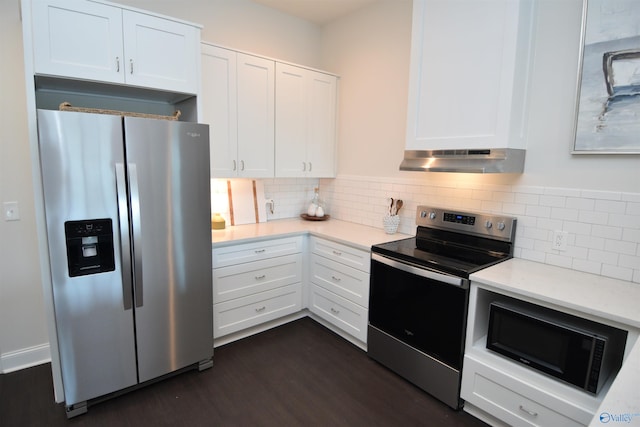 kitchen featuring white cabinets, tasteful backsplash, appliances with stainless steel finishes, extractor fan, and dark hardwood / wood-style floors