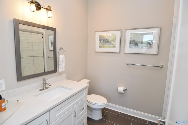 bathroom with vanity, toilet, and tile patterned flooring