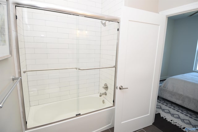 bathroom featuring tile patterned floors and shower / bath combination with glass door