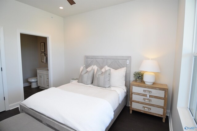 bedroom featuring dark hardwood / wood-style flooring, connected bathroom, and ceiling fan