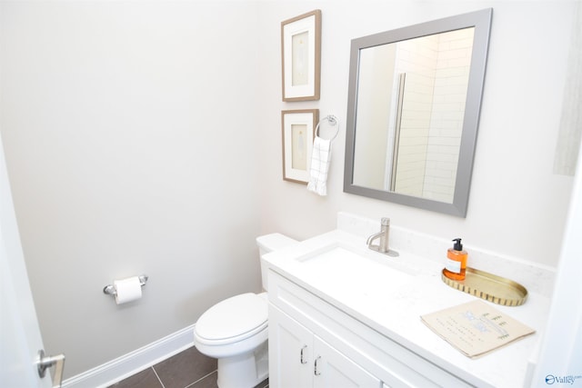 bathroom with vanity, toilet, and tile patterned flooring