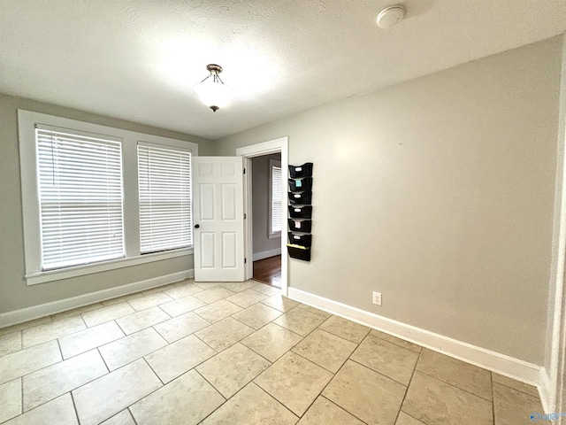 753 Walnut St, Gadsden, AL 35901 - spare room featuring baseboards and light tile patterned floors