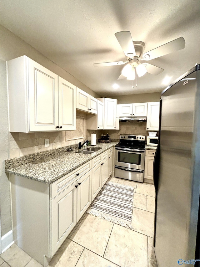 753 Walnut St, Gadsden, AL 35901 - kitchen featuring appliances with stainless steel finishes, a sink, ceiling fan, and backsplash