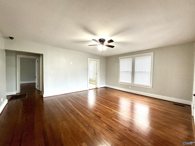 753 Walnut St, Gadsden, AL 35901 - empty room featuring a ceiling fan, dark wood-style flooring, and baseboards