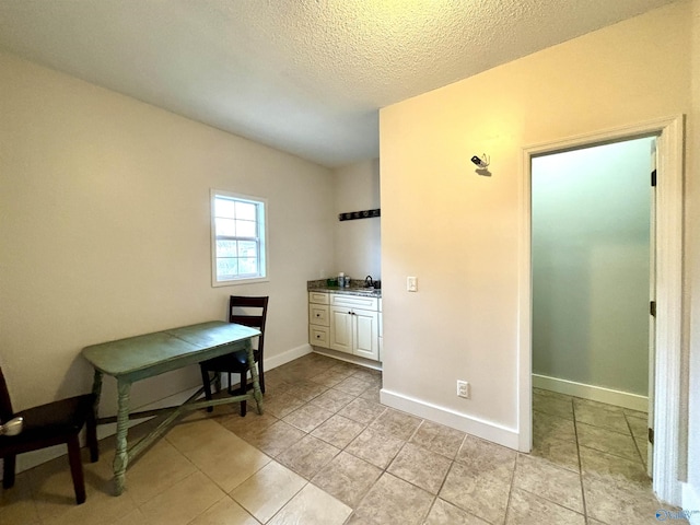 753 Walnut St, Gadsden, AL 35901 - dining area with light tile patterned flooring, baseboards, and a textured ceiling