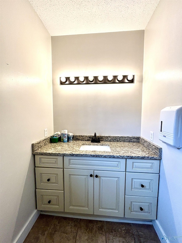 753 Walnut St, Gadsden, AL 35901 - bathroom with vanity, a textured ceiling, and baseboards