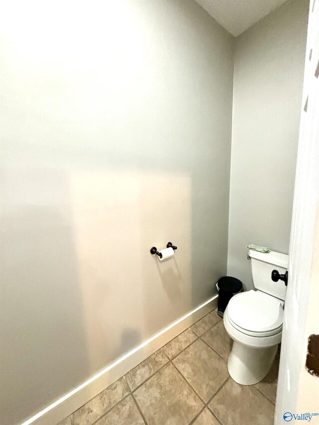 753 Walnut St, Gadsden, AL 35901 - bathroom with toilet, tile patterned floors, and baseboards