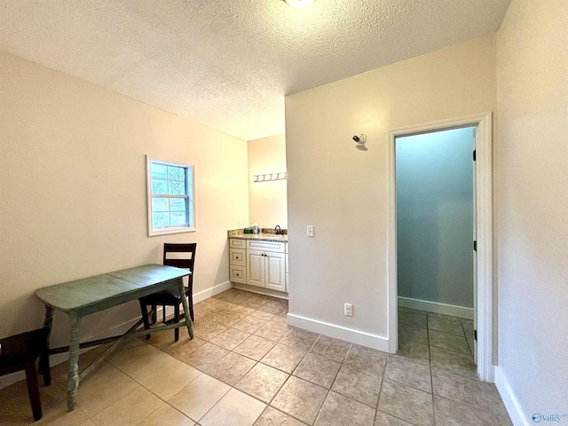 753 Walnut St, Gadsden, AL 35901 - dining area with a textured ceiling, light tile patterned flooring, and baseboards