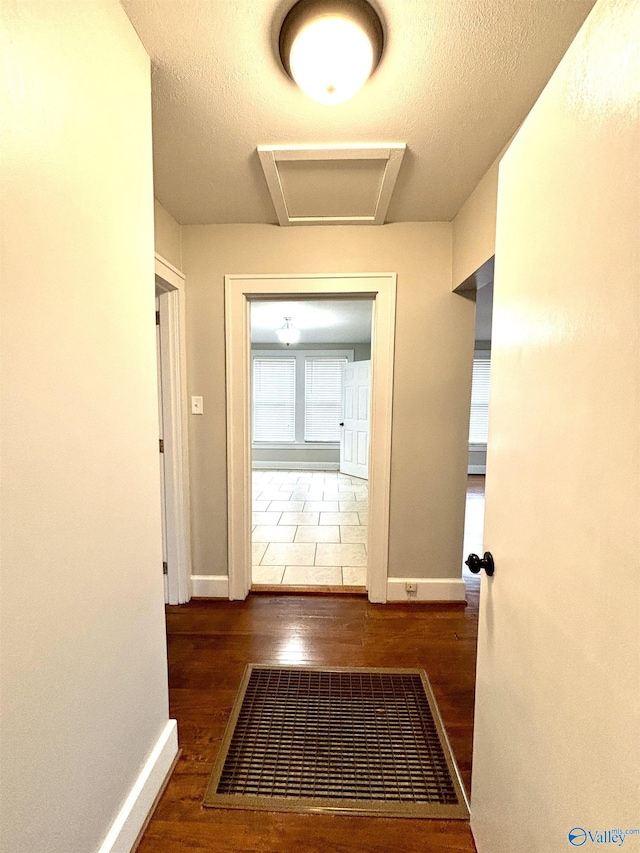 753 Walnut St, Gadsden, AL 35901 - corridor featuring wood finished floors, baseboards, and attic access
