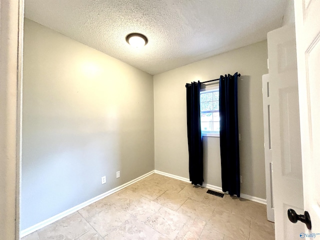 753 Walnut St, Gadsden, AL 35901 - spare room with a textured ceiling and baseboards