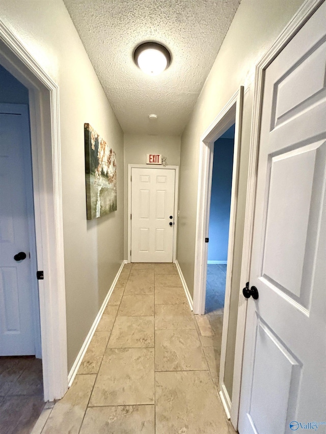 753 Walnut St, Gadsden, AL 35901 - hallway featuring a textured ceiling and baseboards