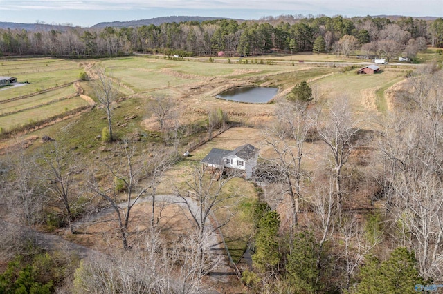 birds eye view of property with a water view, a rural view, and a view of trees