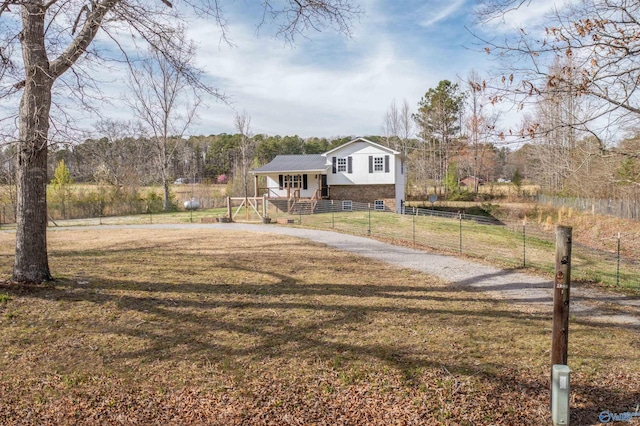 view of front of home with a front yard and a fenced front yard