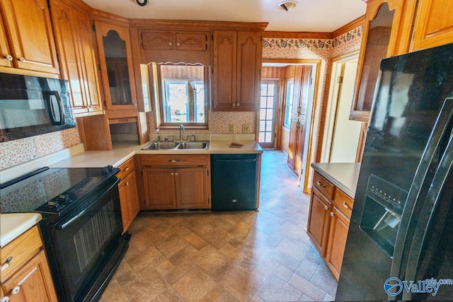 kitchen featuring black appliances, backsplash, and sink