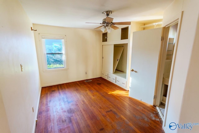 unfurnished bedroom featuring ceiling fan and dark wood-type flooring