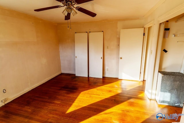 unfurnished bedroom featuring hardwood / wood-style flooring, ceiling fan, and crown molding