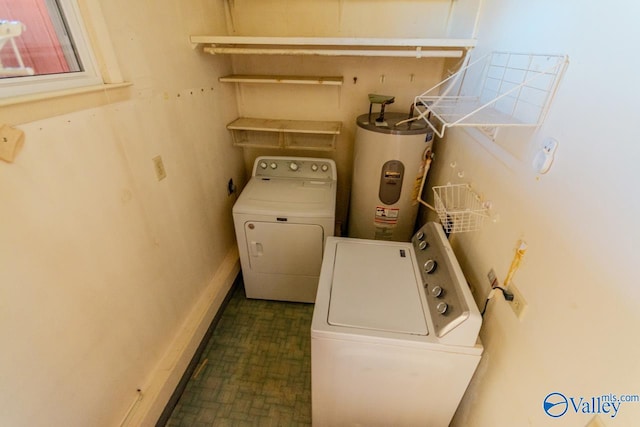 washroom with washing machine and clothes dryer and electric water heater