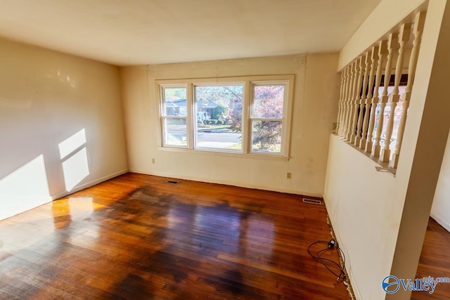 empty room with dark hardwood / wood-style floors