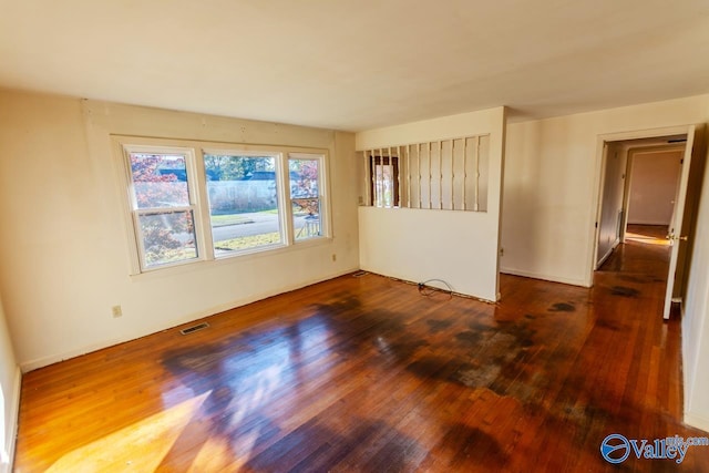 unfurnished room with hardwood / wood-style floors