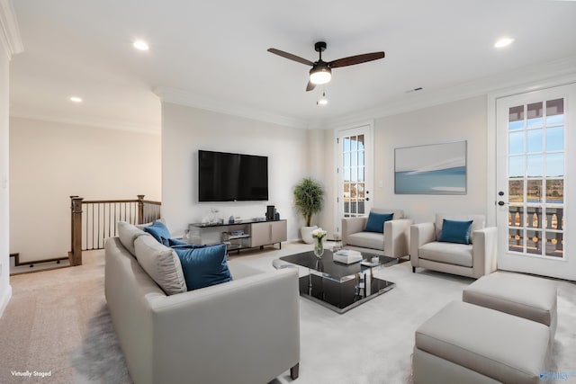 carpeted living room featuring ornamental molding and ceiling fan