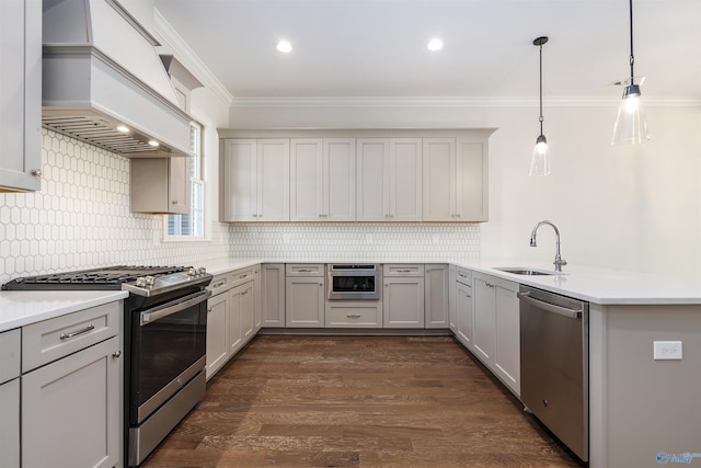 kitchen with gray cabinets, appliances with stainless steel finishes, pendant lighting, sink, and custom exhaust hood