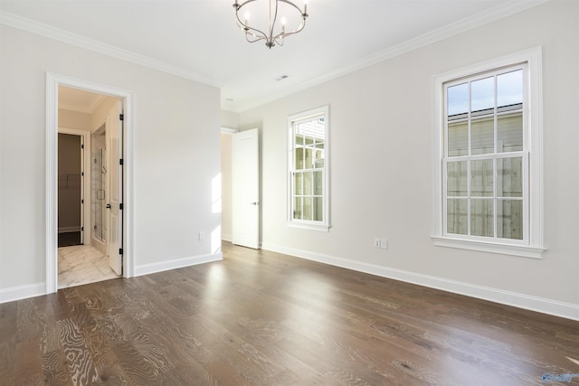 unfurnished room featuring wood-type flooring, ornamental molding, and a chandelier