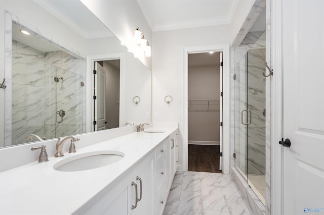 bathroom featuring vanity, a shower with shower door, and ornamental molding