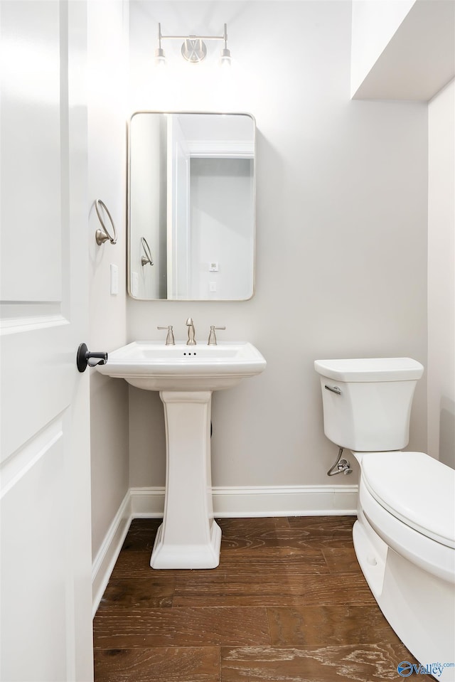 bathroom featuring sink, hardwood / wood-style floors, and toilet