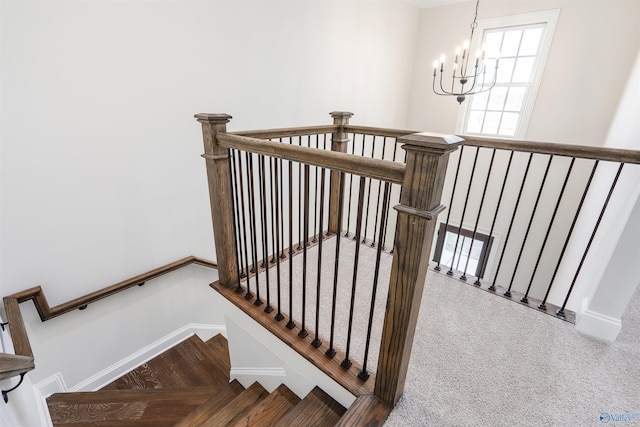 stairs featuring an inviting chandelier