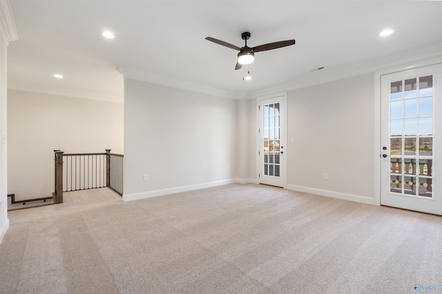 spare room with crown molding, ceiling fan, and light carpet