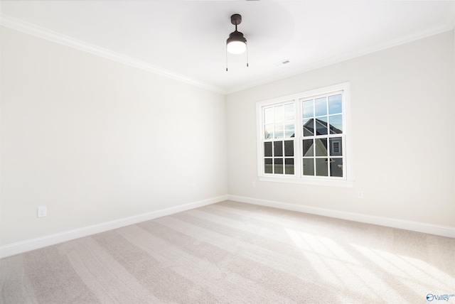 carpeted empty room featuring ornamental molding and ceiling fan