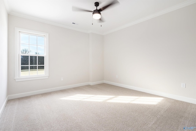 carpeted spare room featuring crown molding and ceiling fan