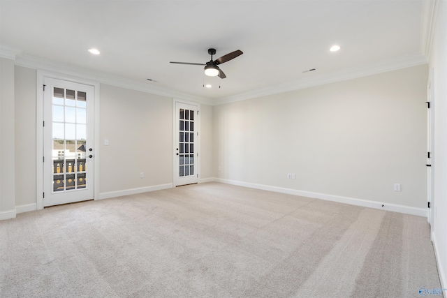 unfurnished room with ceiling fan, light colored carpet, and ornamental molding