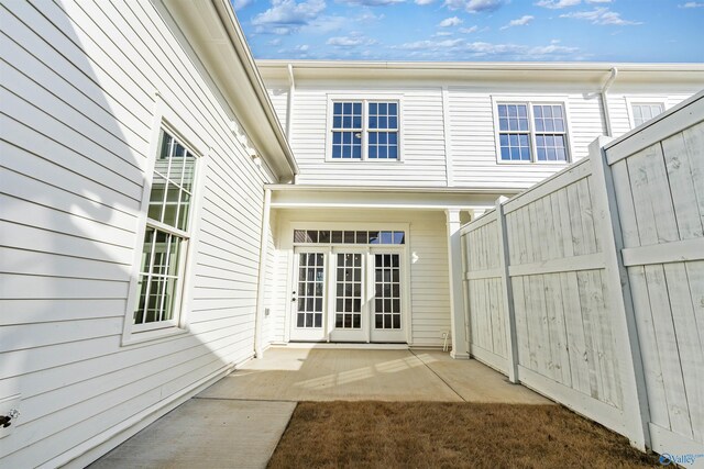 view of exterior entry with a patio