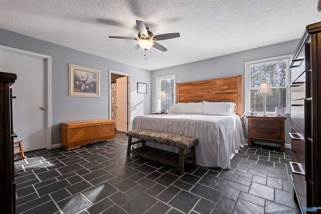 bedroom with a textured ceiling and ceiling fan