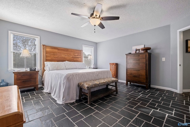 bedroom featuring a textured ceiling and ceiling fan