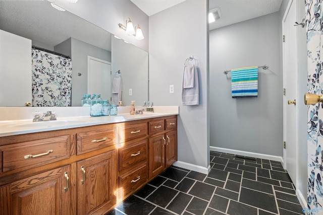 bathroom featuring vanity and a textured ceiling