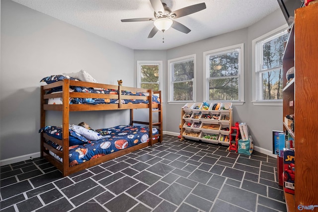 bedroom featuring ceiling fan and a textured ceiling